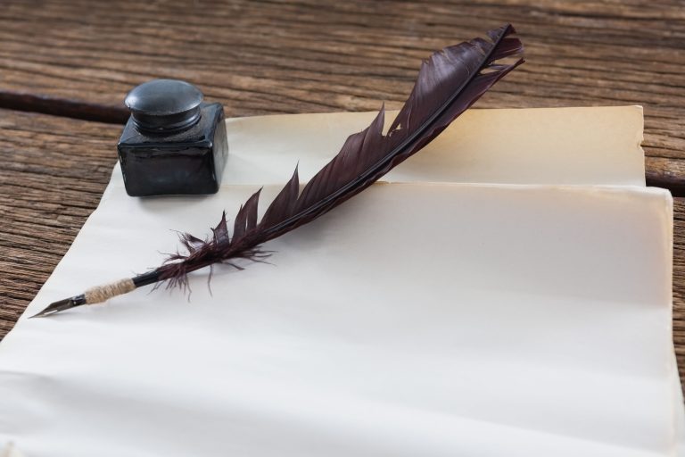 pikwizard quill feather ink bottle and blank document on wooden table